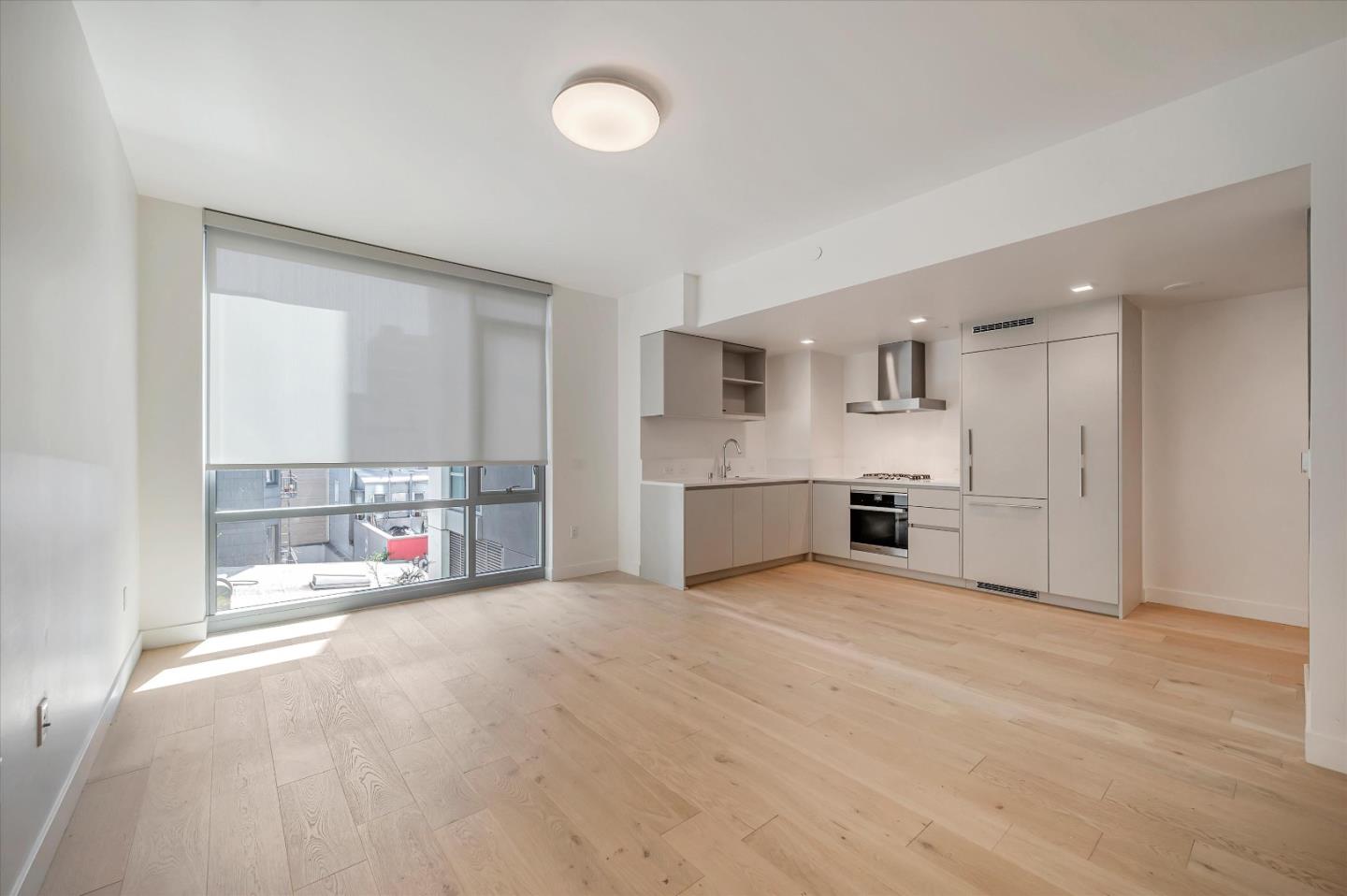 a large white kitchen with white cabinets and a sink