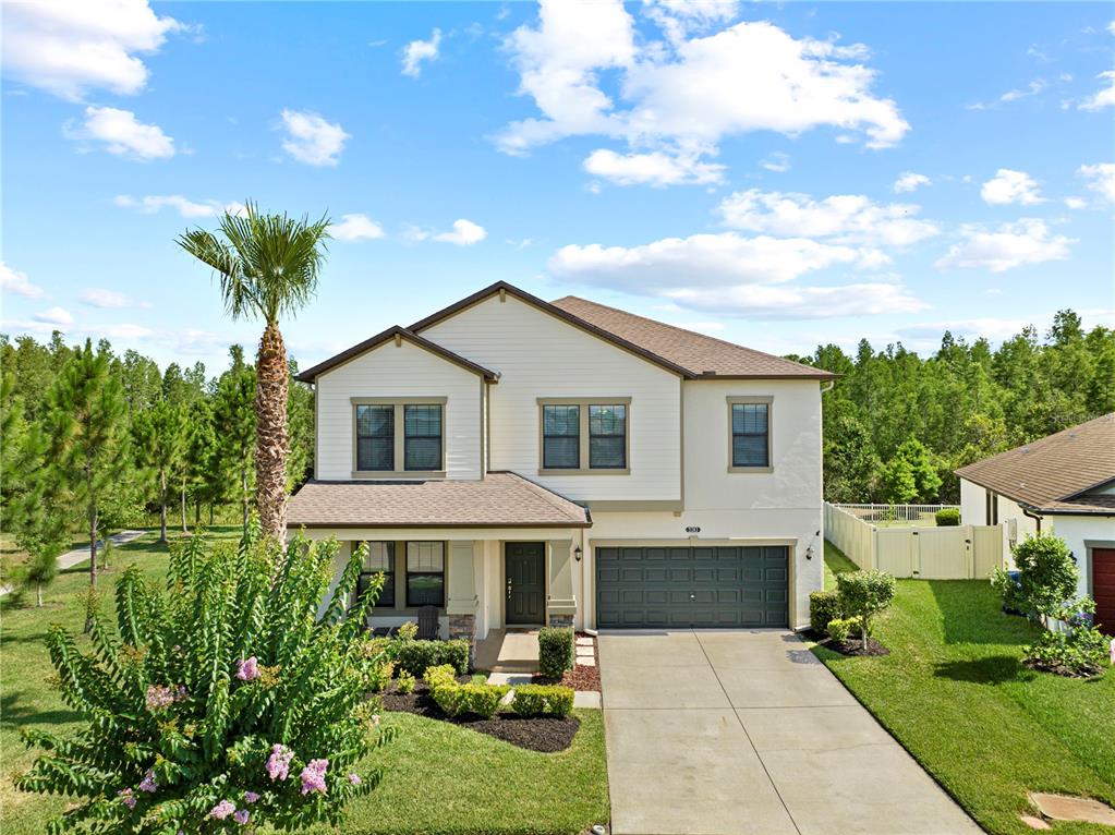 a front view of a house with a garden