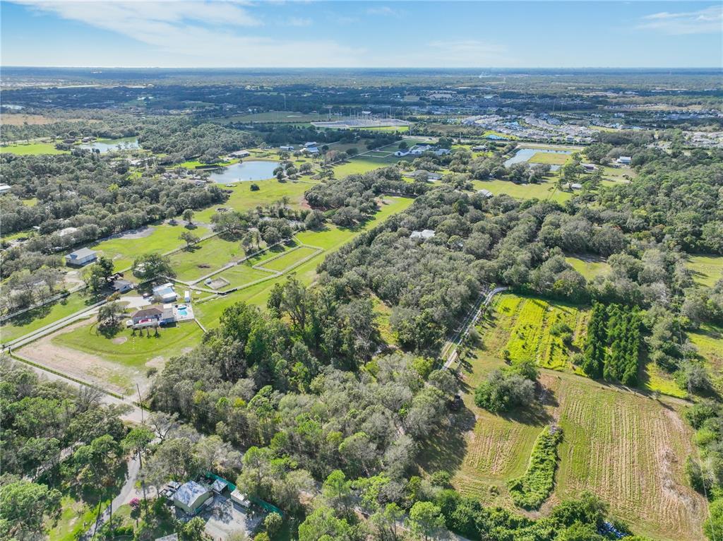 an aerial view of residential houses with outdoor space and swimming pool