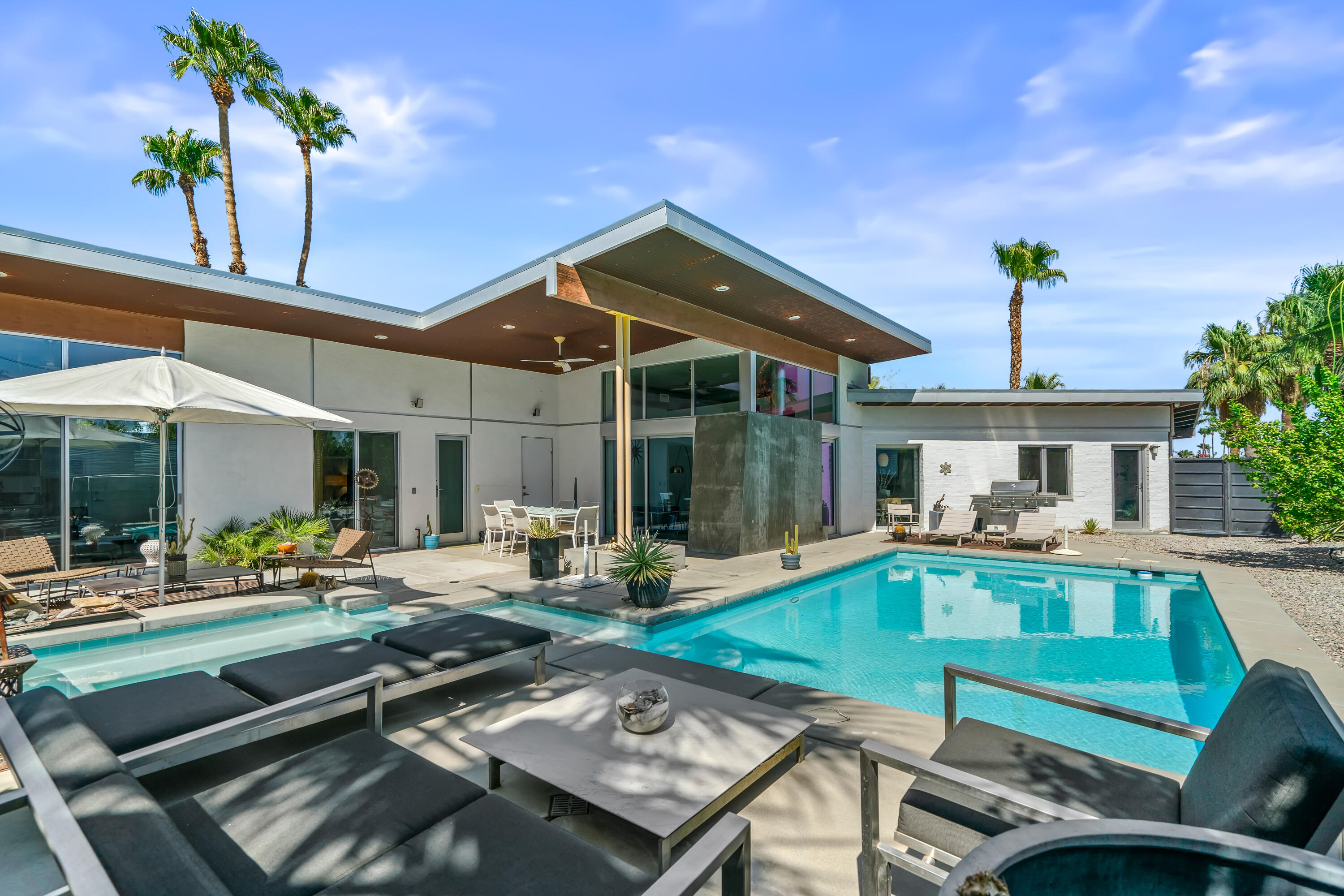 a view of a house with backyard outdoor seating area and furniture