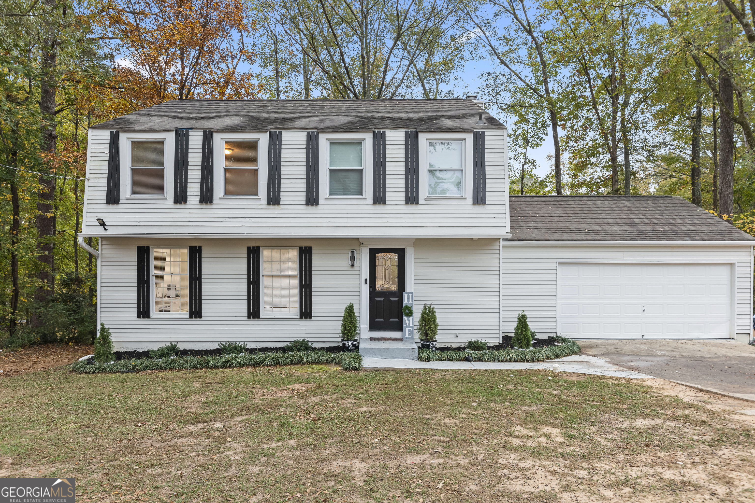 a front view of a house with a yard and garage