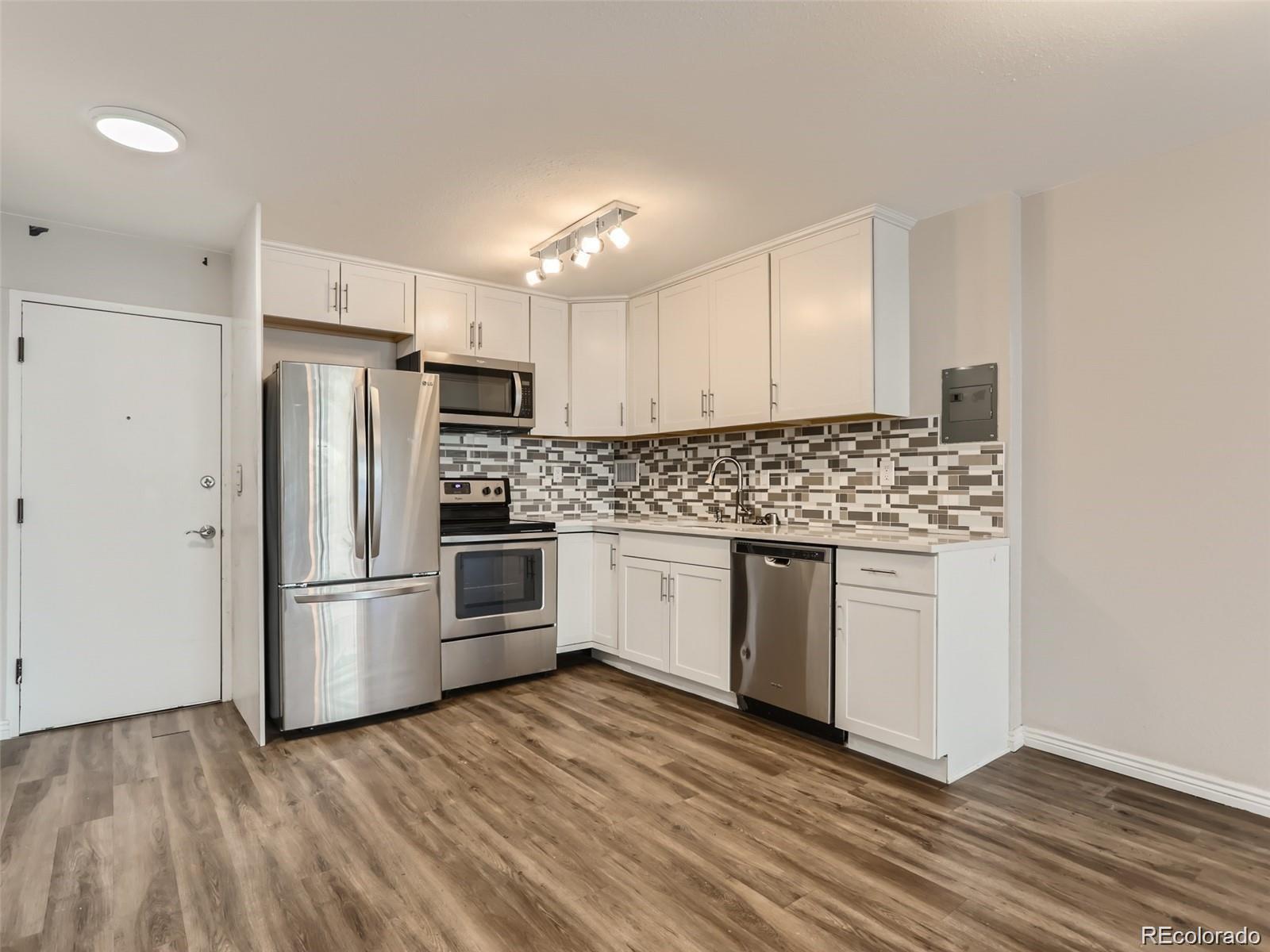 a kitchen with stainless steel appliances a refrigerator sink and microwave