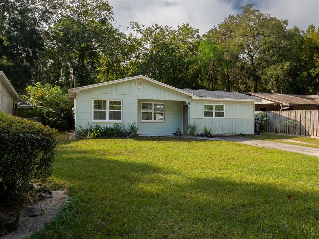 a view of a house with pool and a yard