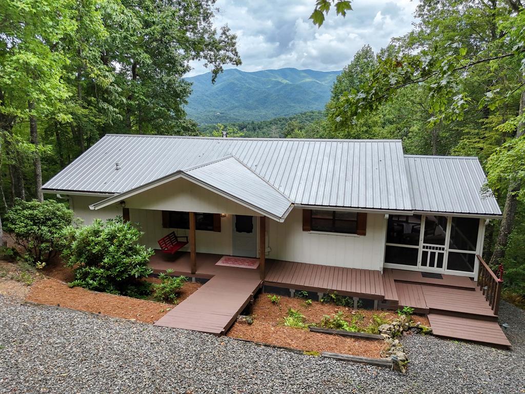 an aerial view of a house with a yard balcony and furniture