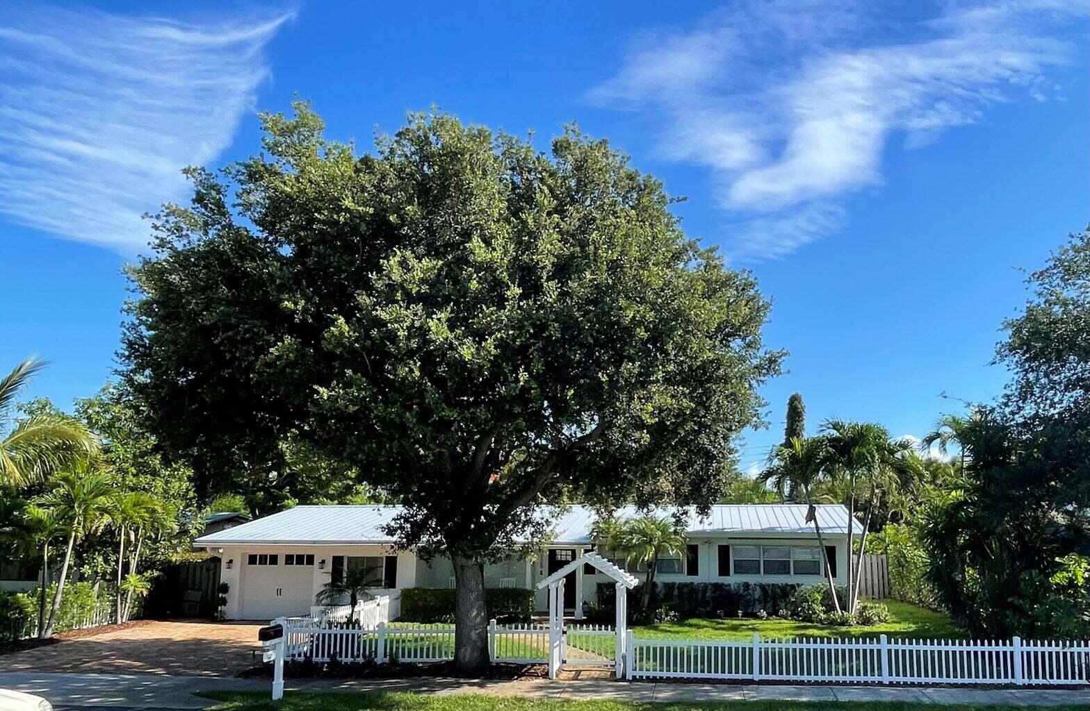 a front view of a building with trees