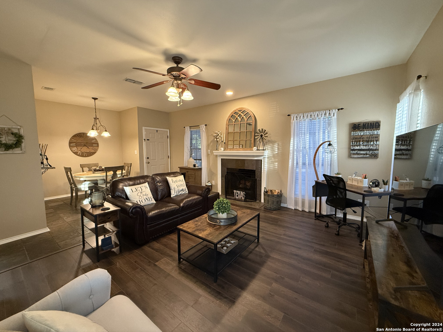 a living room with furniture a fireplace and a flat screen tv