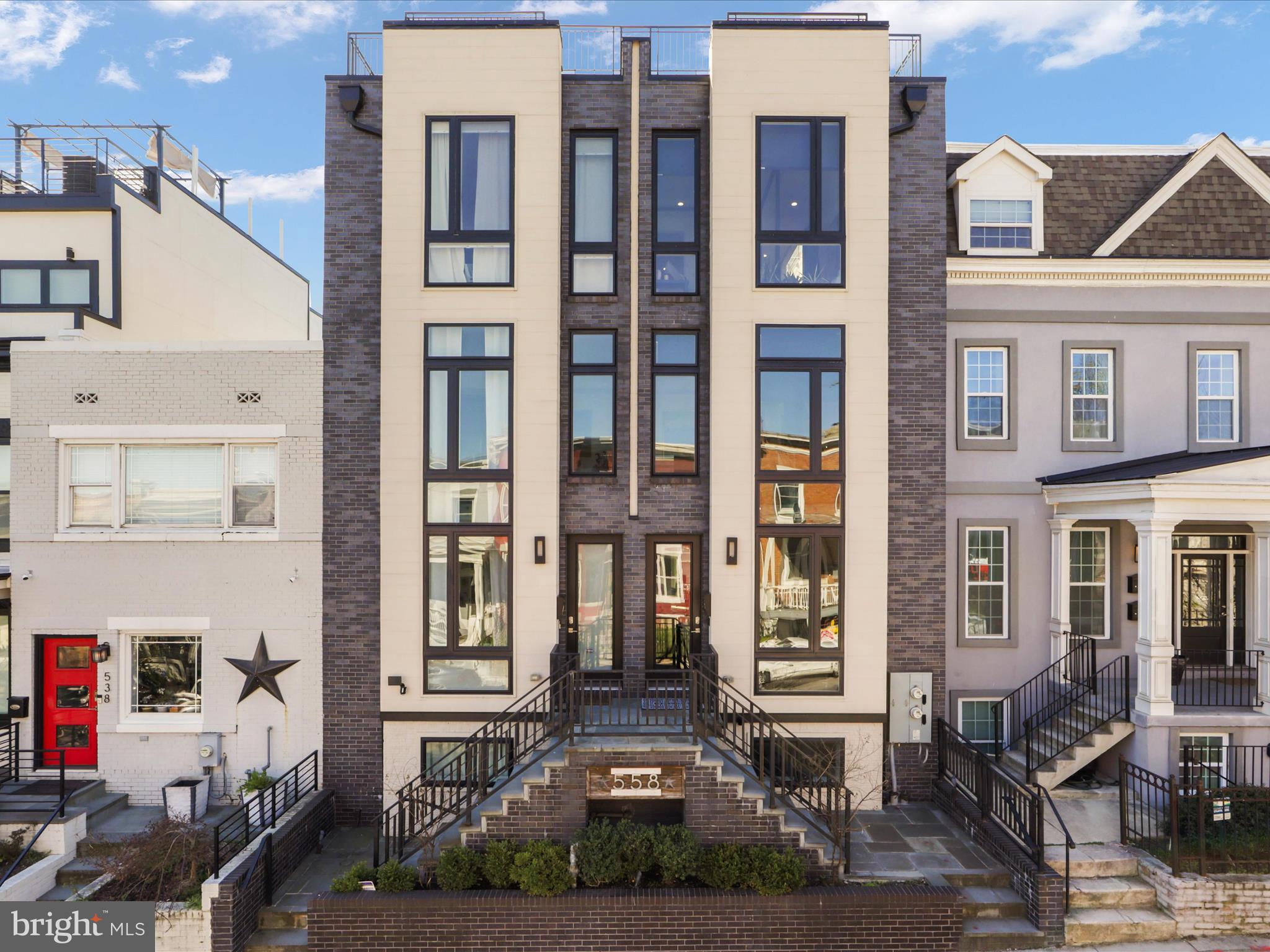 a front view of a residential apartment building with a yard