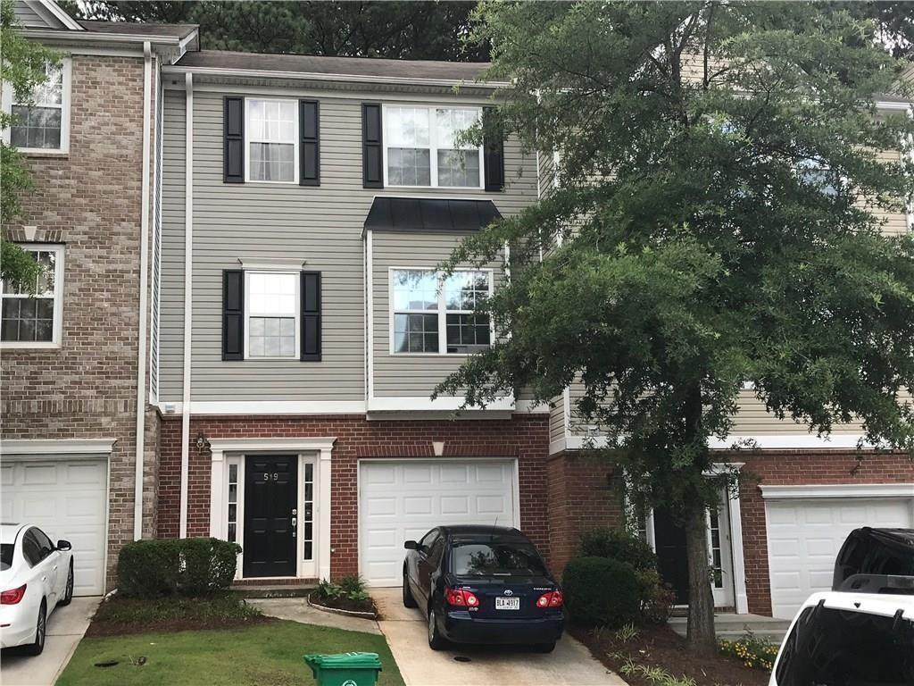 a car parked in front of a brick house