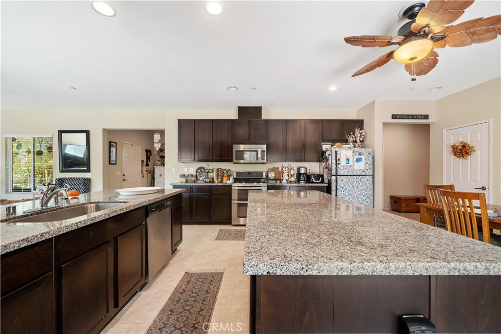 a large kitchen with kitchen island a large counter space appliances and cabinets