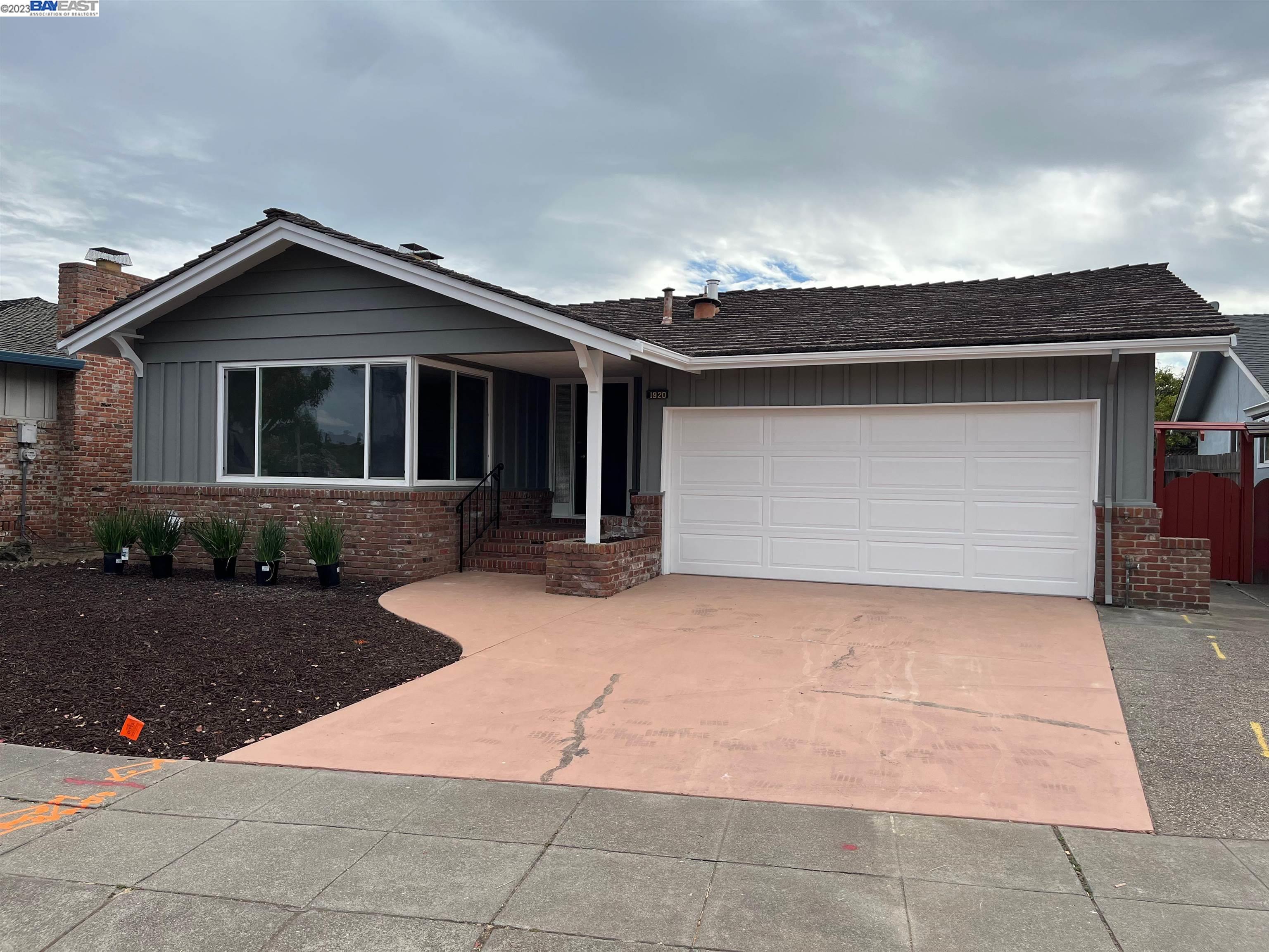 a front view of house with yard garage and seating