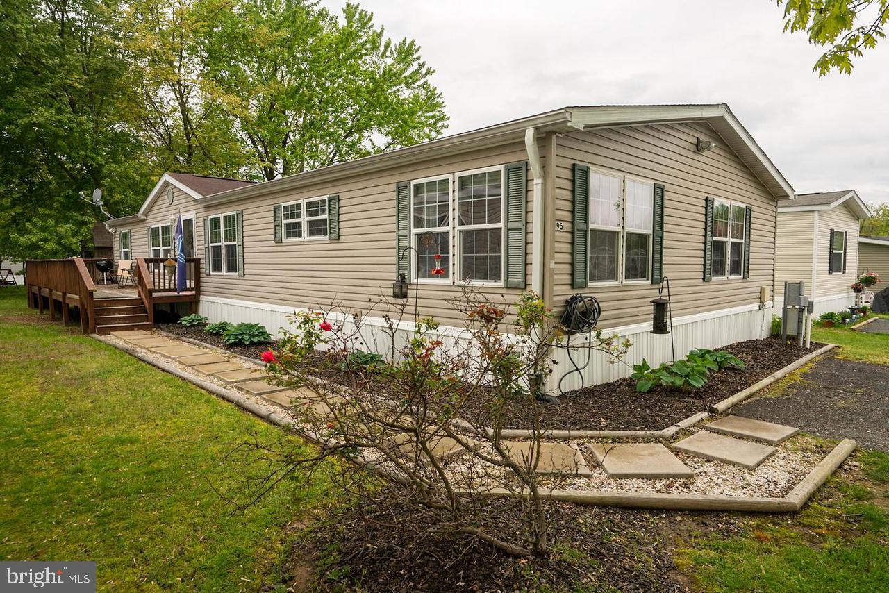 a front view of a house with a yard and porch