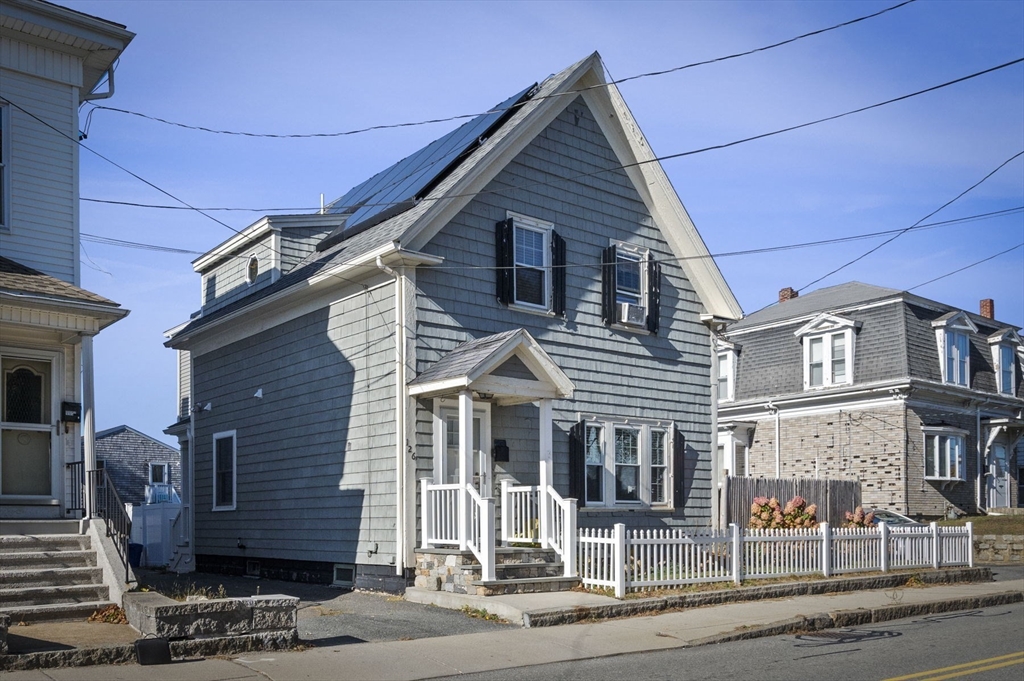 a front view of a house with a street