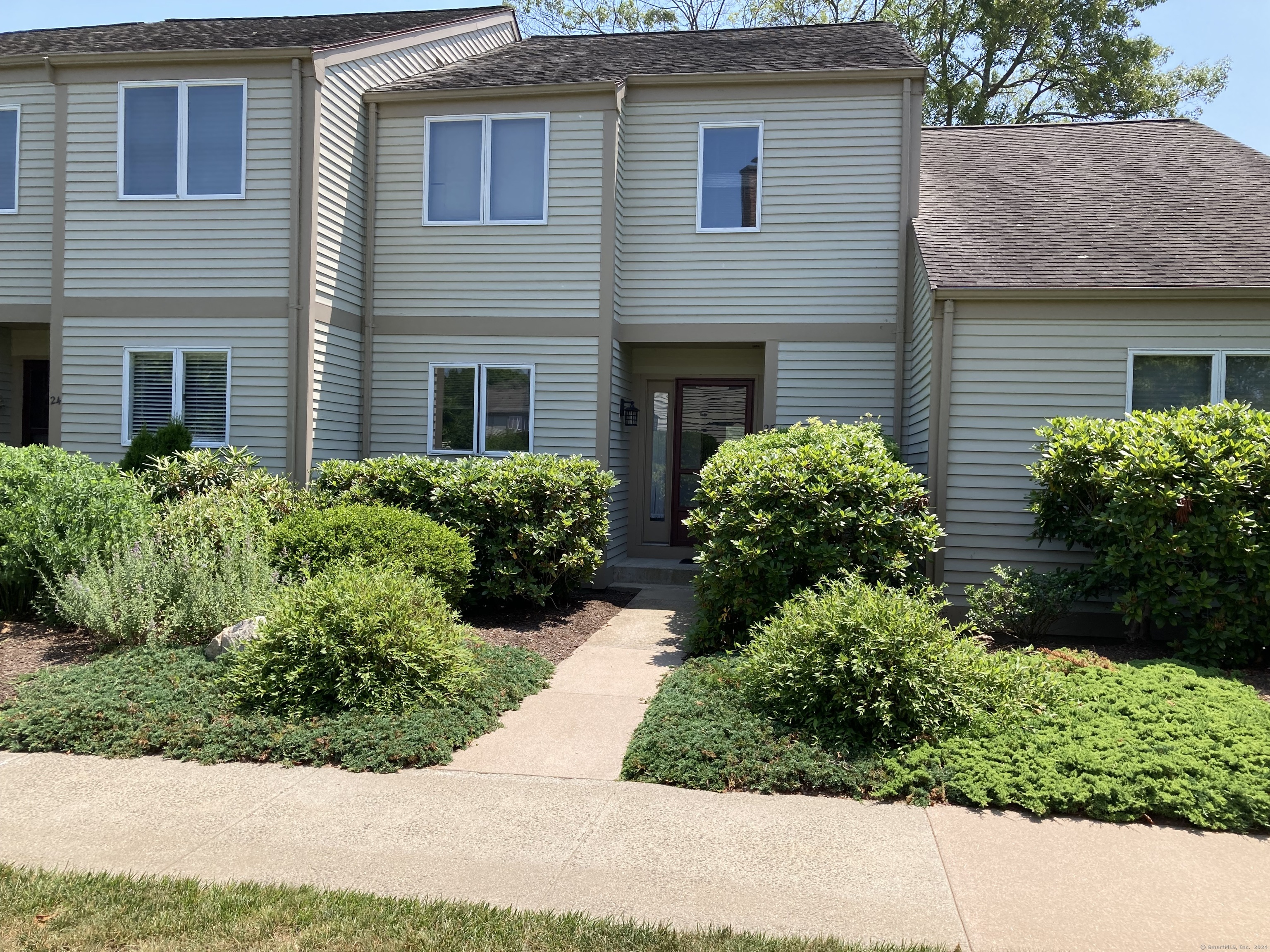 a front view of house with yard and green space