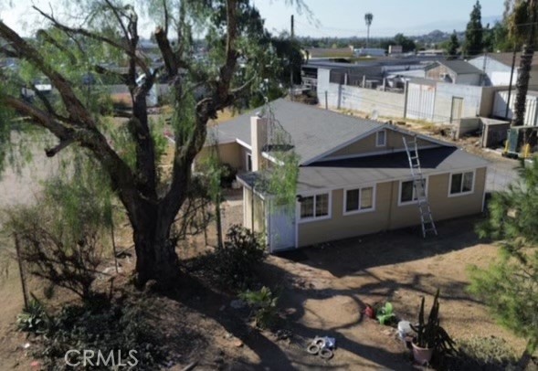 a aerial view of a house with a yard table and chairs