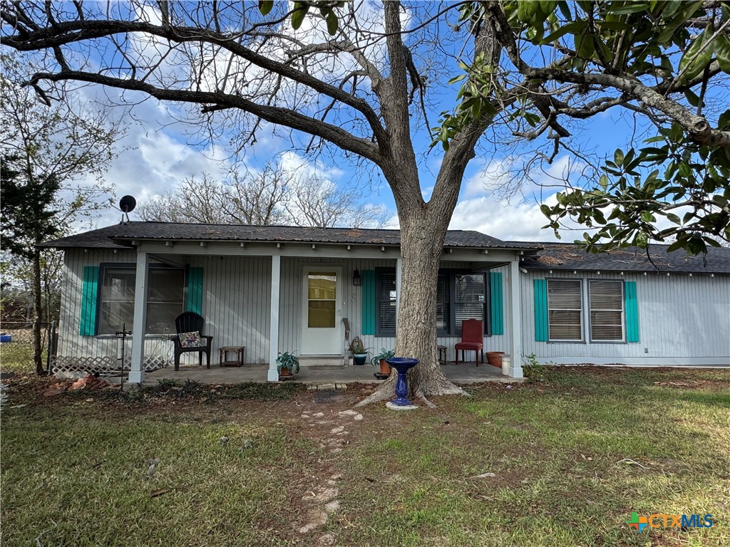 a front view of a house with lots of trees