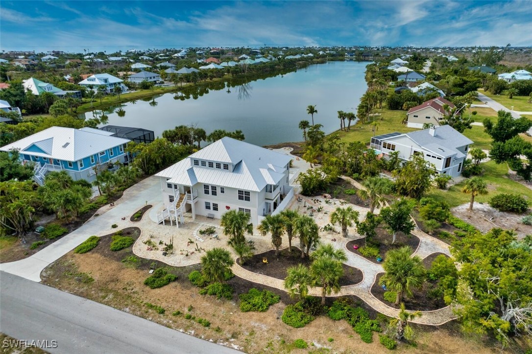 an aerial view of a house with a lake view