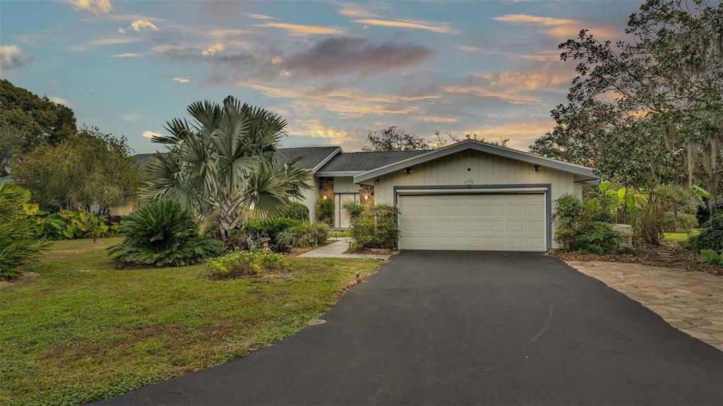 a view of a house with a yard and garage