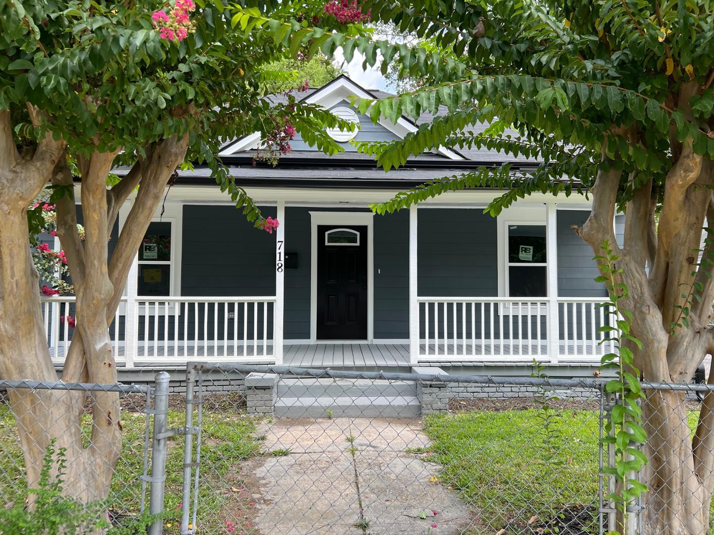 a front view of a house with a garden