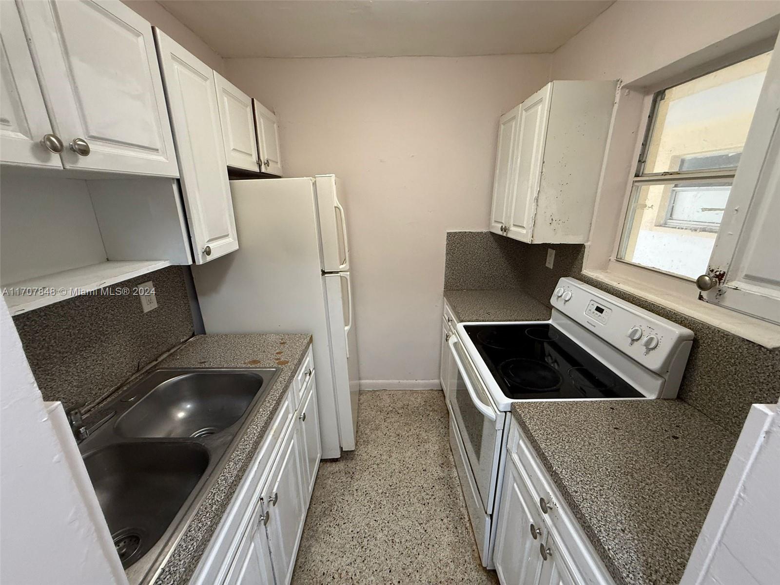 a kitchen that has a sink and a stove