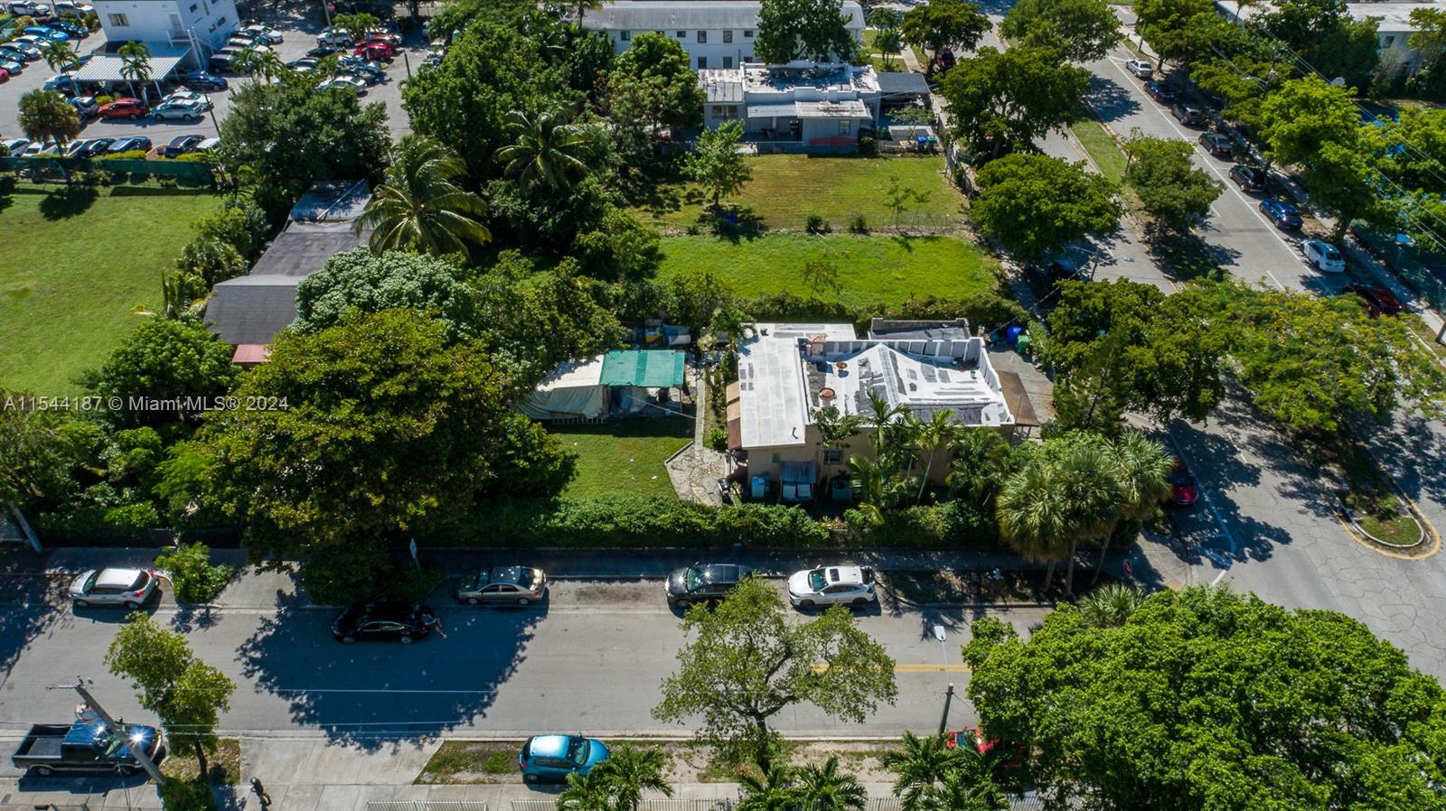 an aerial view of a house with a yard and lake view