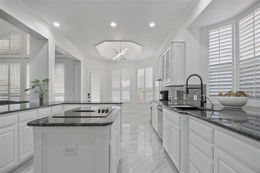 a kitchen with sink stove and cabinets