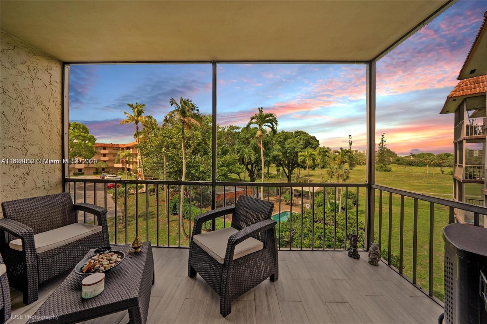 a view of a balcony with couches and wooden floor