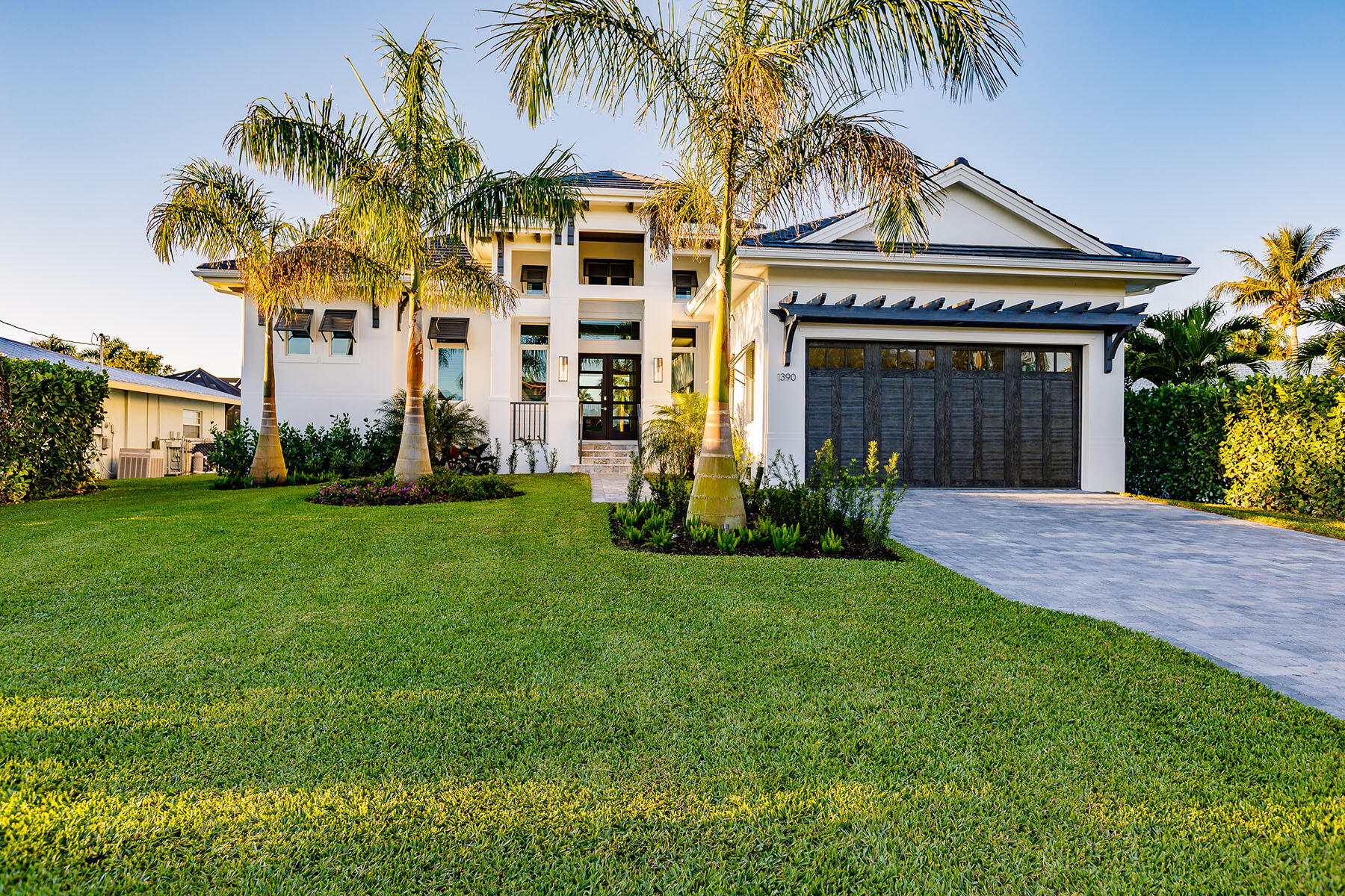 a front view of a house with a garden