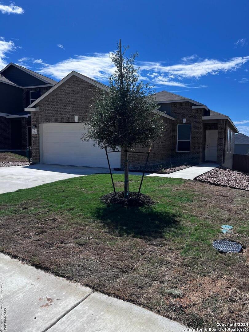 a front view of a house with garden