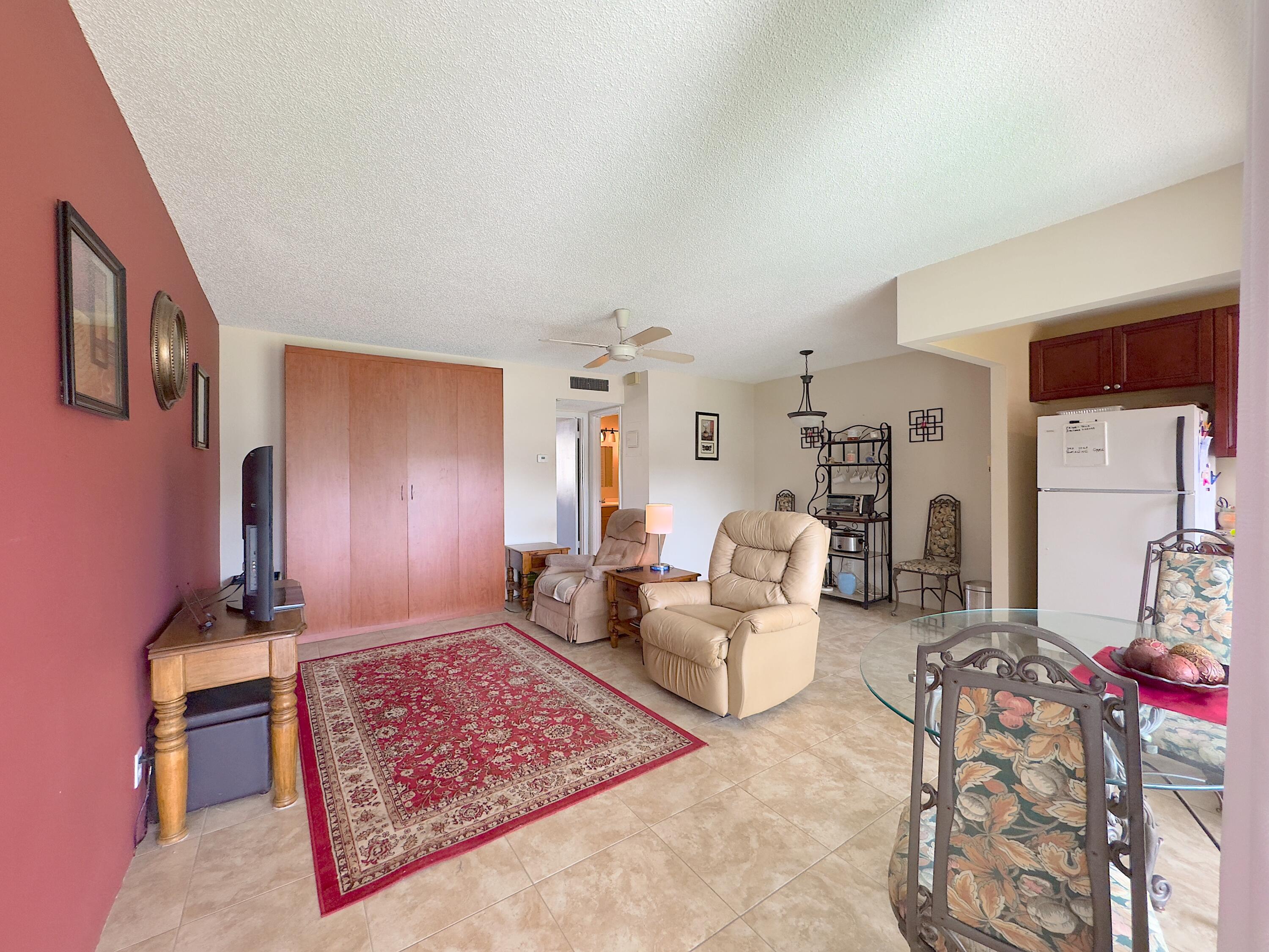 a living room with furniture rug and a window