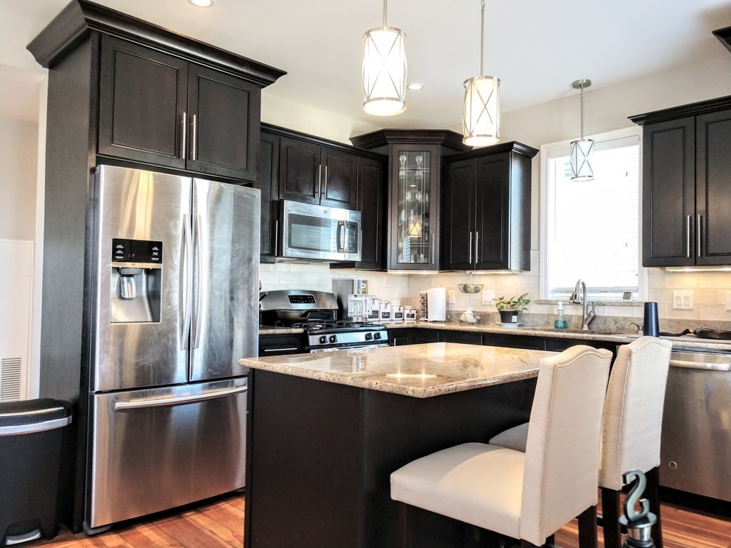 a kitchen with a sink stainless steel appliances and refrigerator