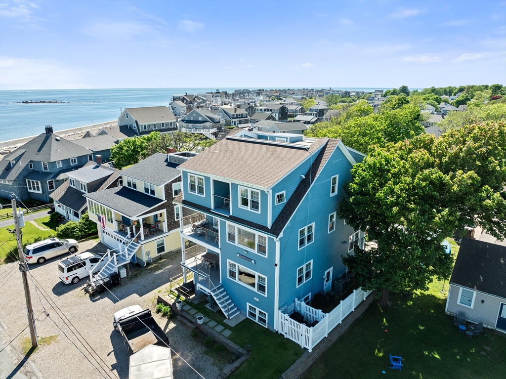 an aerial view of multiple houses with a yard