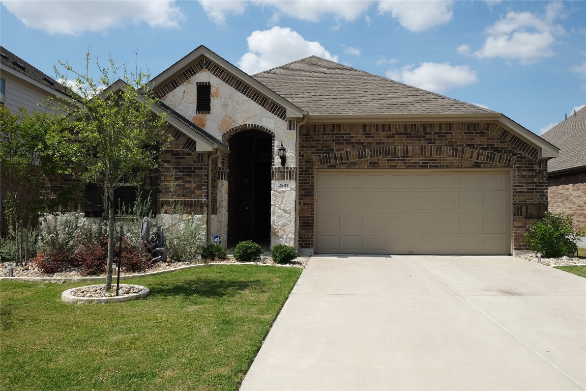 a front view of a house with a yard