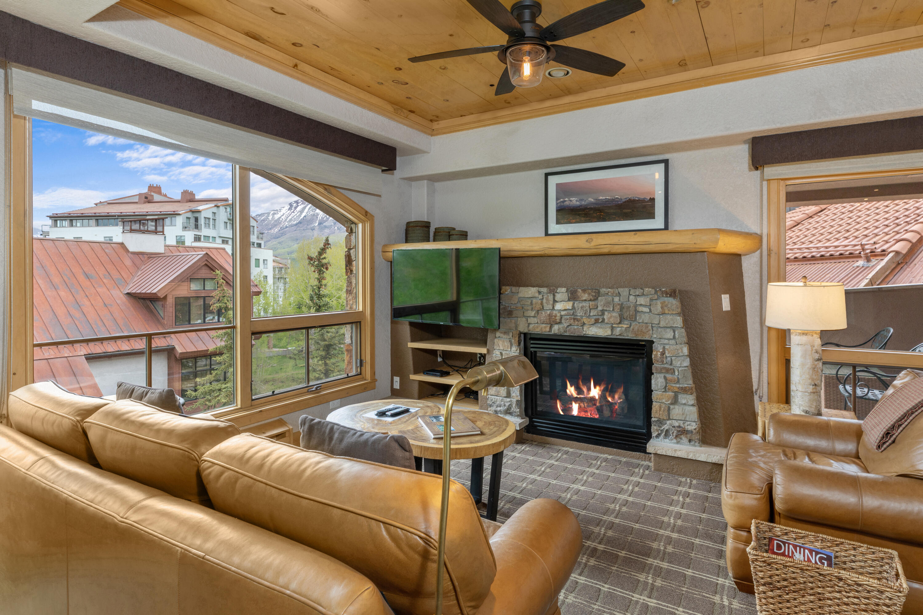 a living room with furniture a large window and a fireplace