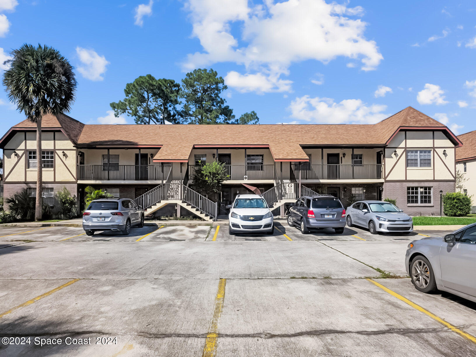 a view of a cars park in front of a house