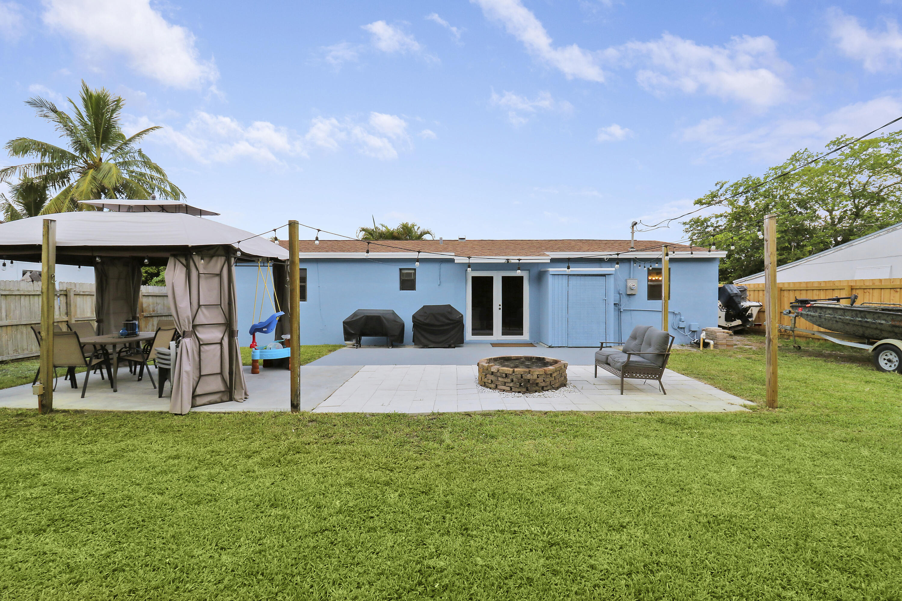 a view of a house with backyard sitting area and garden