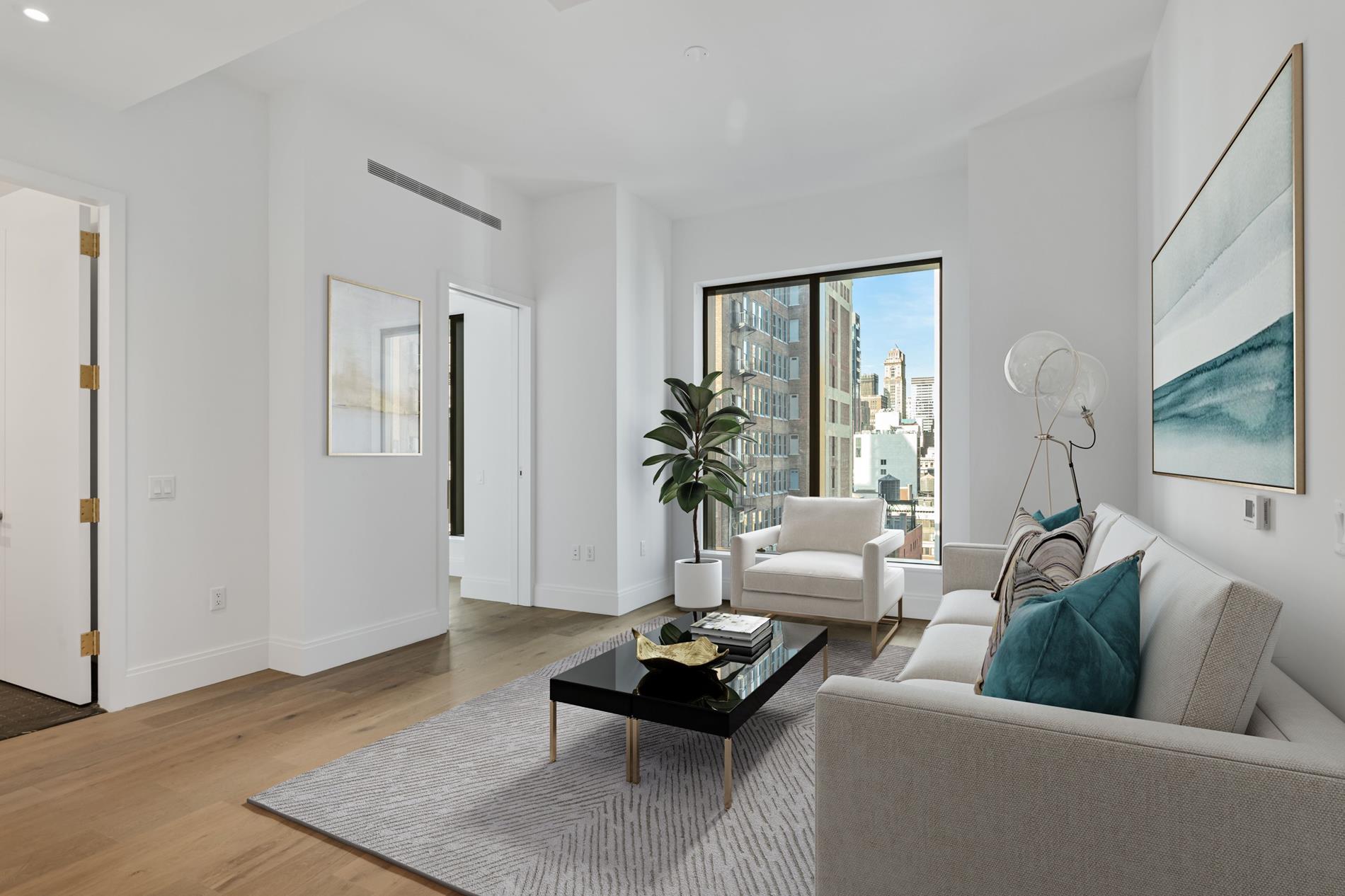 a living room with furniture and wooden floor