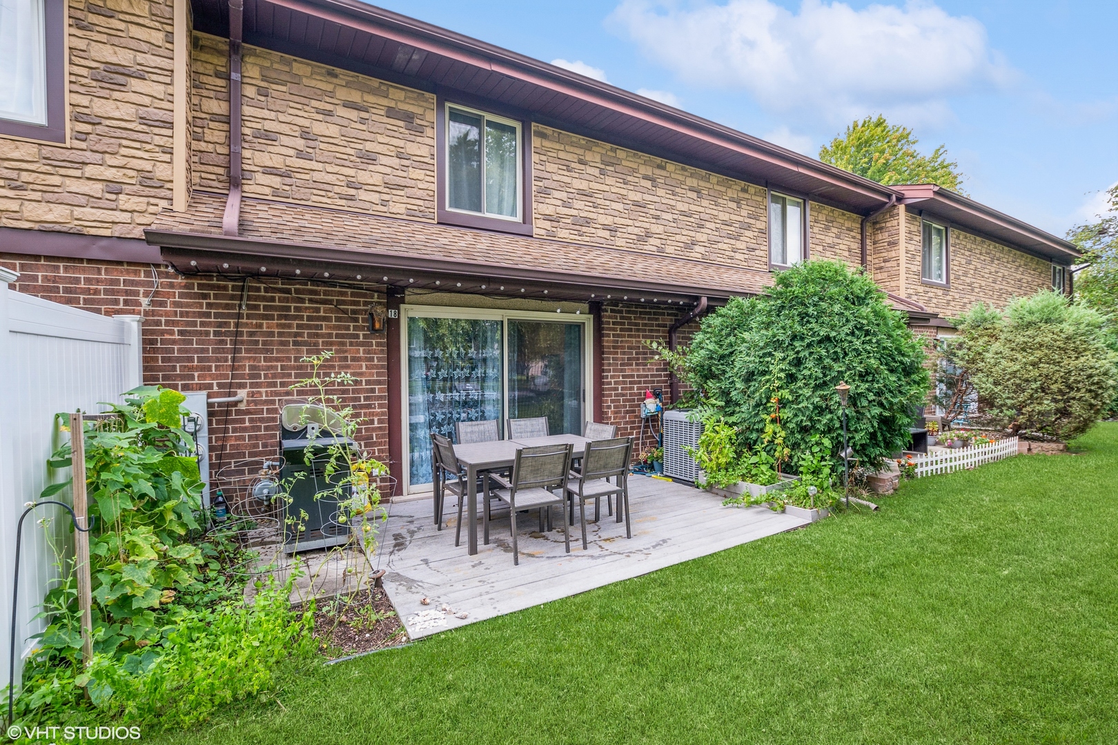 a view of a house with patio and a yard