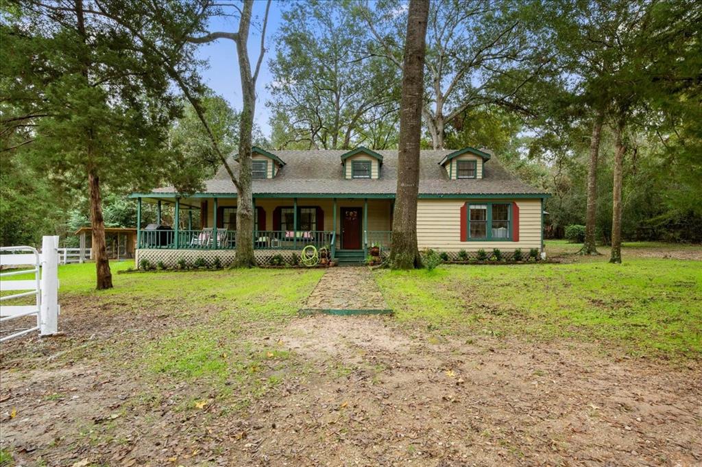 a front view of a house with a yard and trees