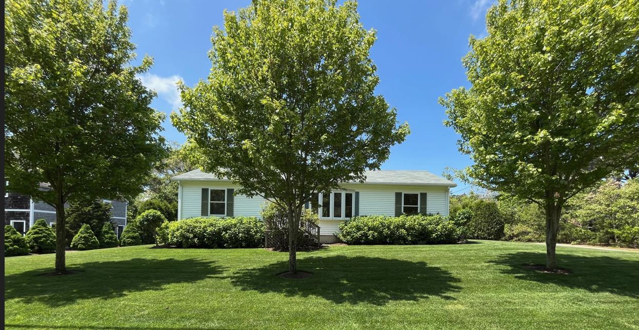 a front view of a house with a yard