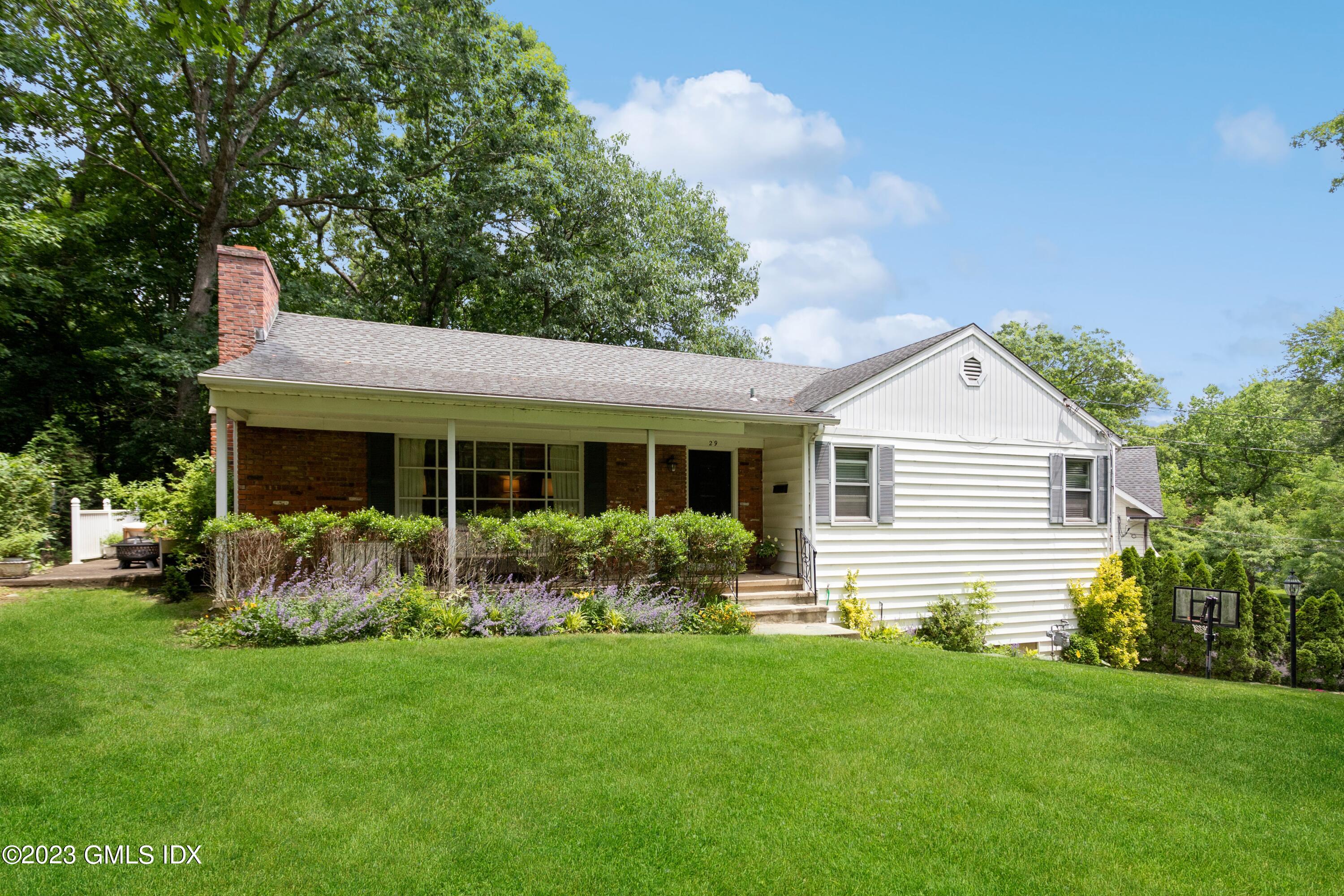 a front view of house with yard and outdoor seating