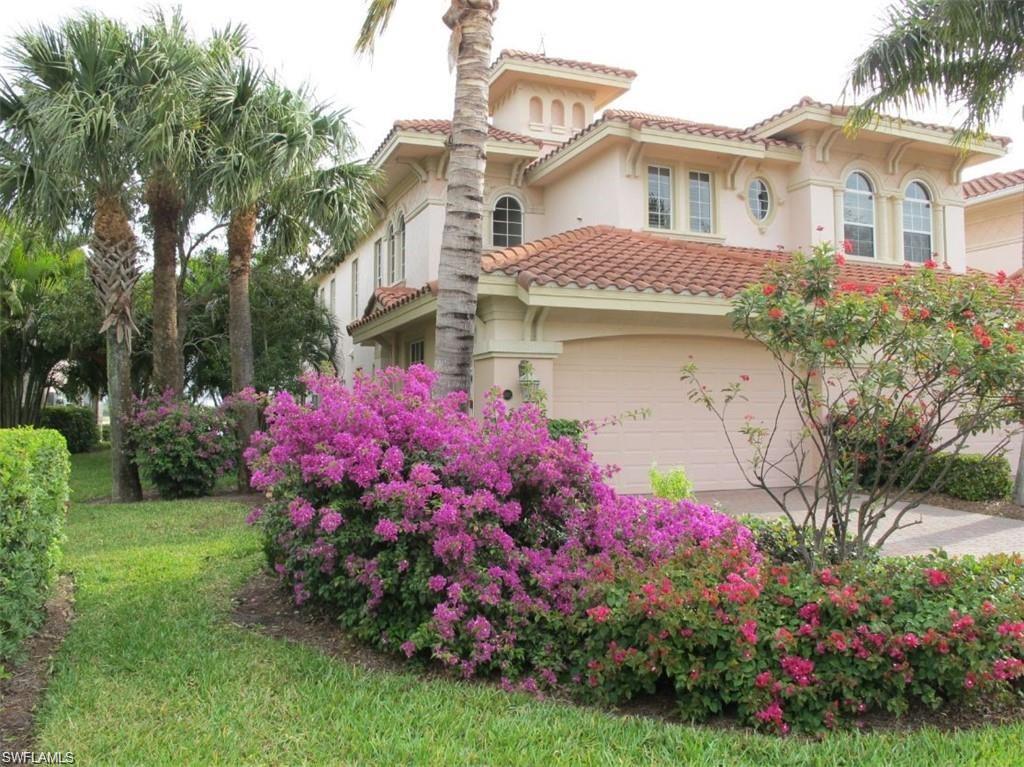 a front view of a house with a yard and fountain