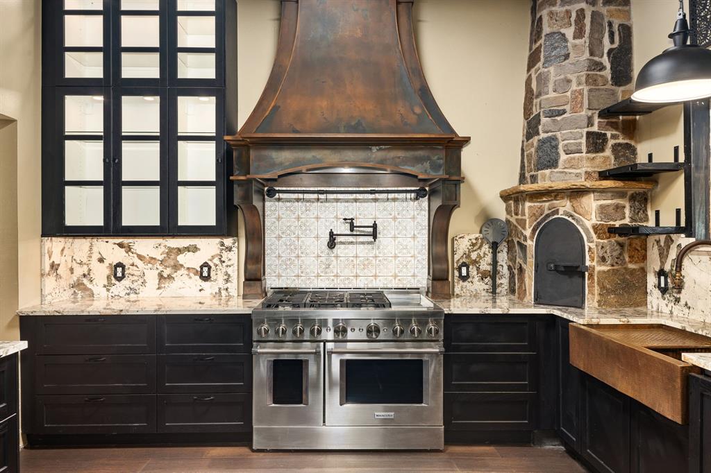 a stove top oven sitting inside of a kitchen