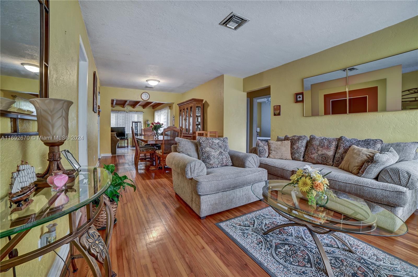 a living room with furniture fireplace and a table