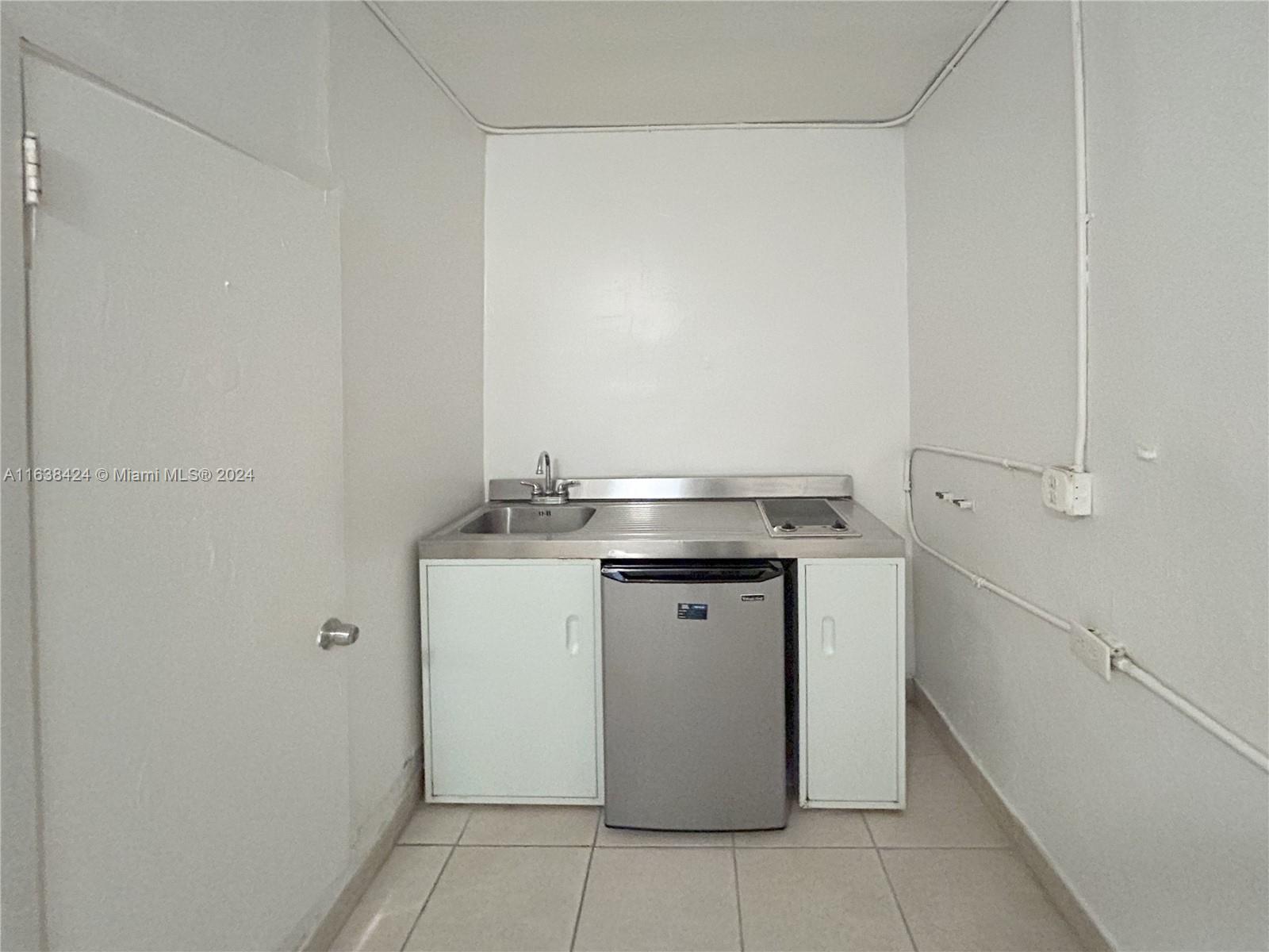 a utility room with a sink washer and dryer