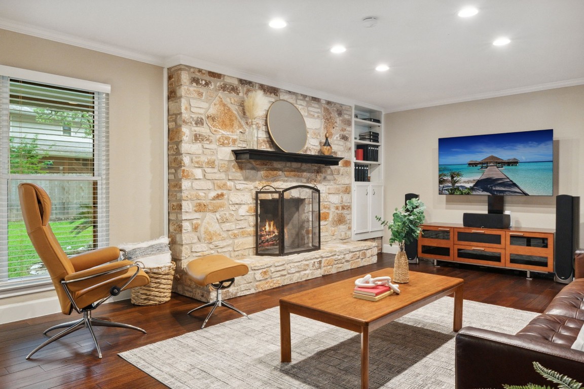 a living room with furniture a flat screen tv and a fireplace