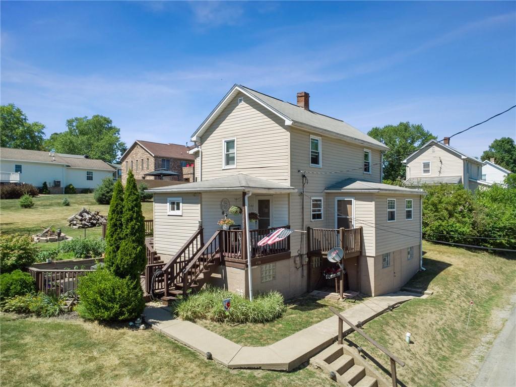 an aerial view of a house with a yard