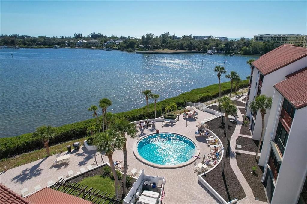 an aerial view of a house with outdoor space and lake view