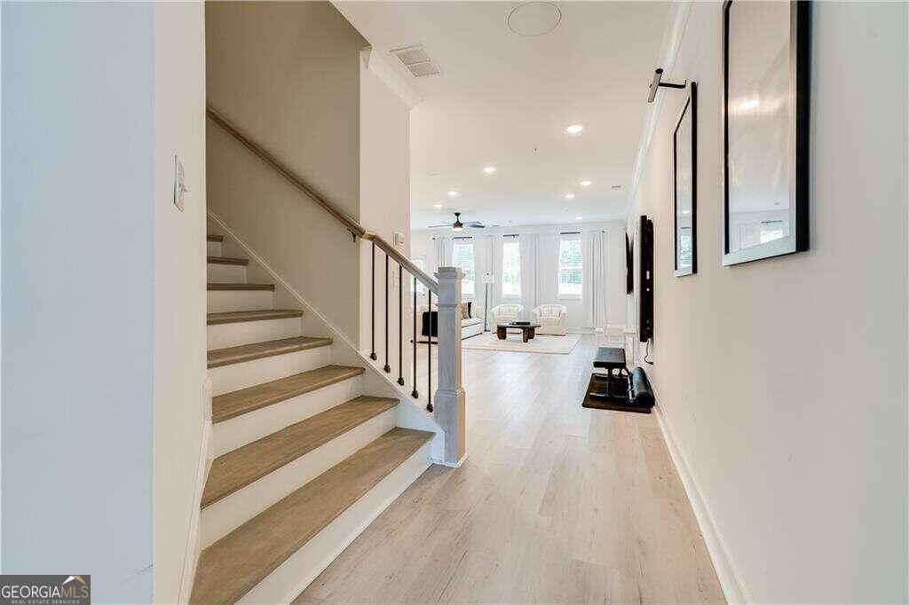 a view of entryway and hall with wooden floor