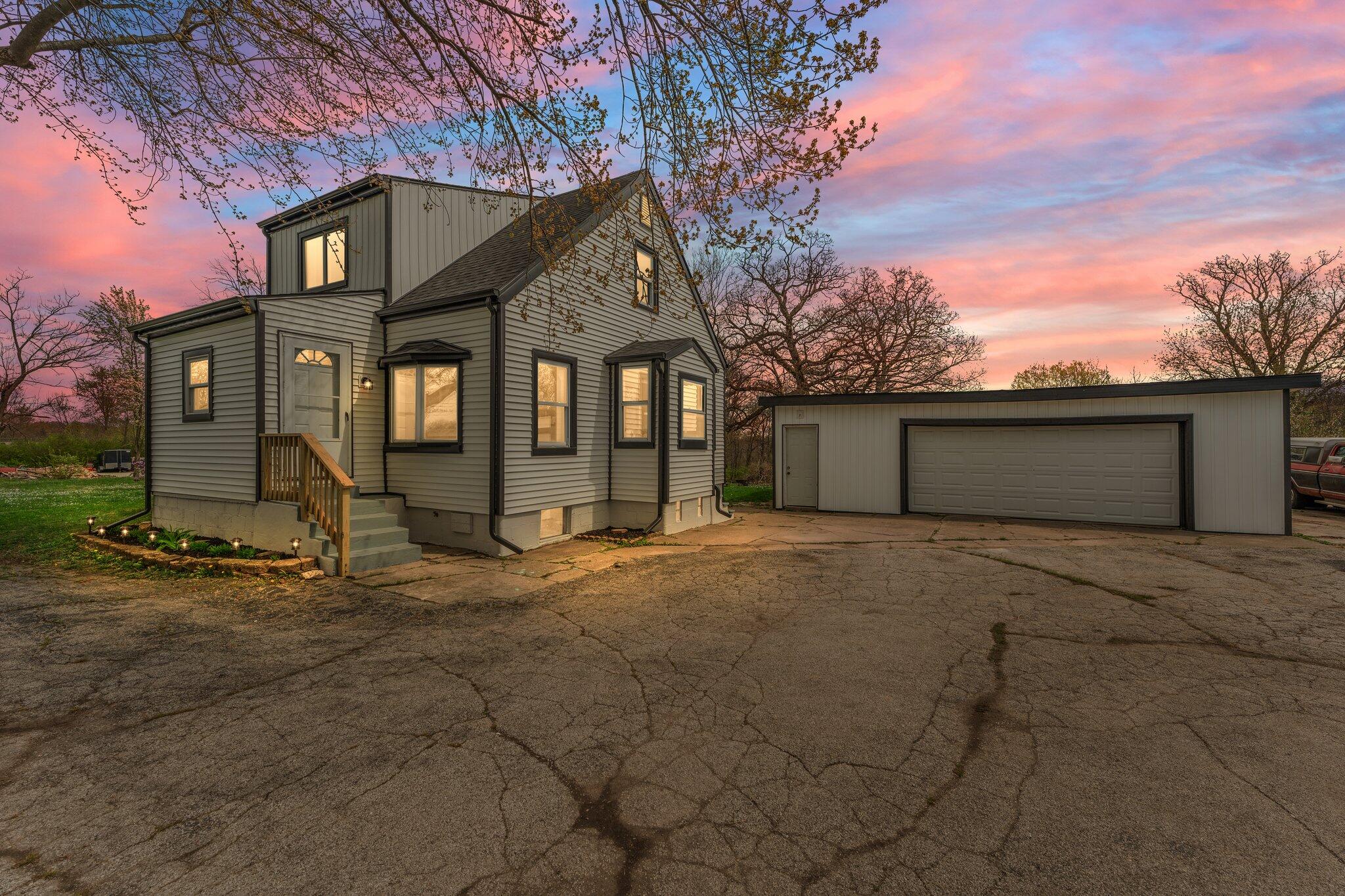 a view of a house with a yard and garage