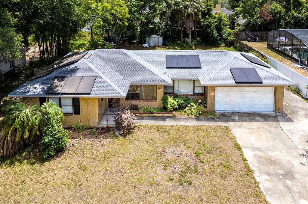 a aerial view of a house with a yard and plants